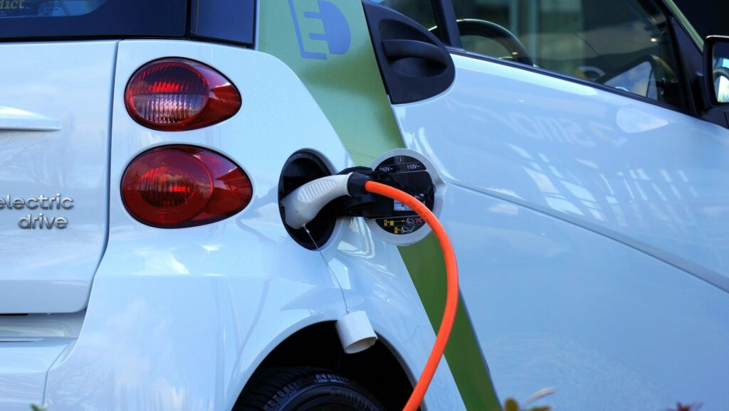 Close-up of an electric car being charged, highlighting eco-friendly transportation.